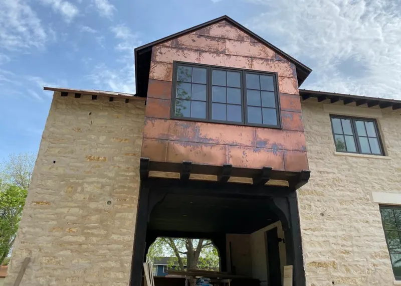 Copper metal panel facade on a stone building for Skylight Installation in Mililani Town